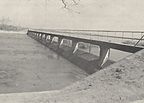 Spillway showing catwalk during heavy rain in 1946